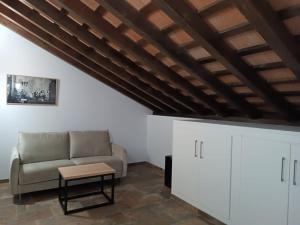 a living room with a couch and a table at Hospedería La Cilla in La Puebla de Cazalla