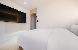 Postel nebo postele na pokoji v ubytování Hotel Yam Sangmu