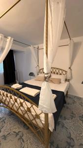 a bedroom with a bed with a canopy at Forest house in Eforie Nord