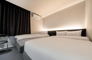 Postel nebo postele na pokoji v ubytování Hotel Yam Sangmu