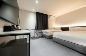 Postel nebo postele na pokoji v ubytování Hotel Yam Sangmu