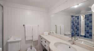 a white bathroom with a sink and a toilet at OurMadeira - Villa do Mar I, secluded in Arco da Calheta +18 photos