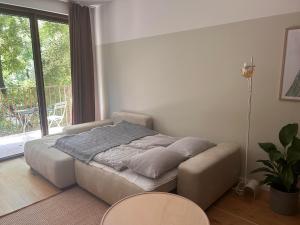 a bed in a room with a large window at Apartment Zwirn, free parking, 24/7 access in Nivy