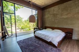 A bed or beds in a room at One Brick Great Wall Heritage B&B