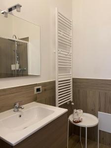 a bathroom with a white sink and a mirror at Casa Torre Chimera in Sommatino +33 photos