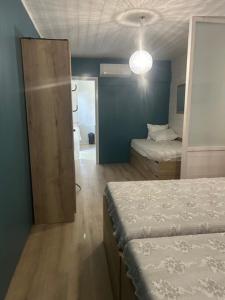 a bedroom with two beds and a door to a bathroom at Camping de Bernadou - Le Lodge in Villemur-sur-Tarn