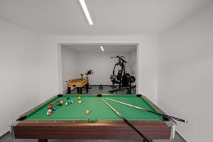 a snooker room with a pool table and a gym at Villa Nene in Benažići