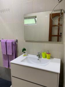 a bathroom with a white sink and a mirror at Katila Morro Coral in Espargos