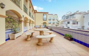 a patio with tables and seats on a balcony at 2 Bedroom Stunning Apartment In Nerja in Nerja