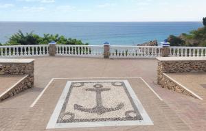 a rug with an anchor on it on a patio overlooking the ocean at 2 Bedroom Stunning Apartment In Nerja in Nerja +27 photos