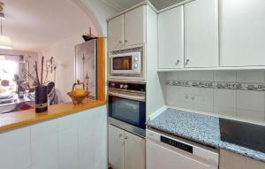 a kitchen with white cabinets and a stove top oven at 2 Bedroom Stunning Apartment In Nerja in Nerja