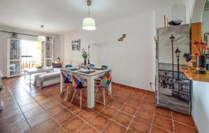 a kitchen and living room with a table and chairs at 2 Bedroom Stunning Apartment In Nerja in Nerja