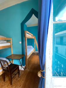 a room with a bed and a table and a window at The Pink House in Faja Grande +93 photos