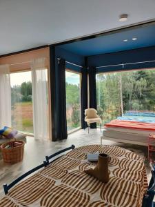 a room with a large bed and a large window at Huoneisto Sipoossa in Helsinki