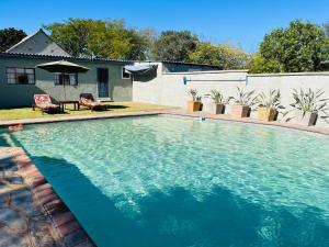 a large swimming pool in front of a house at BelofteBos Farmhouse Inn in Bandelierkop