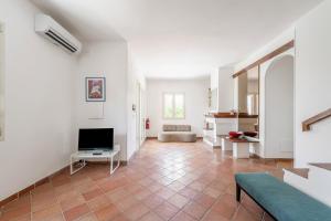 een woonkamer met een bank en een televisie bij Valdemare Relax&Beach in Ostuni