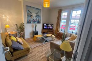 a living room with a couch and a table at Home in London, N14 nearby Trent Park and Alexandra Palace in East Barnet