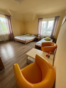 a room with two beds and a couch and a chair at BedRooms 3 Maja 15A in Łódź