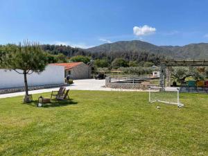 a park with a soccer ball and a goal at Ηλιόπετρα - Iliopetra in Vasilika