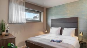Posteľ alebo postele v izbe v ubytovaní VN17 Rooftop Suites by Adrez