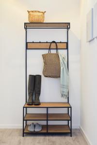 a shelf in a room with boots and a purse at Apartment B10 "Südbalkon mit Haffblick" im Pine Hill Resort in Zirchow