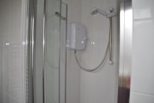 a shower in a bathroom with a phone on the wall at The Studios, Dedworth Road, by Accommodation Windsor in Windsor