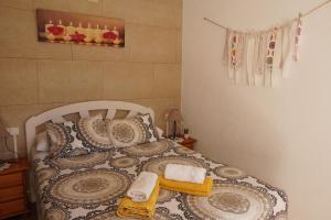 a bedroom with a bed with towels on it at Apartamentos in El Poblenou del Delta