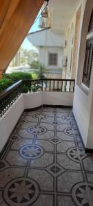 a balcony with a tile floor on a building at Villa El kheer in `Ezbet el-Dabdûba