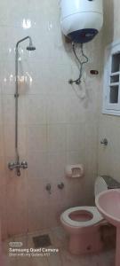 a bathroom with a shower and a toilet and a sink at Villa El kheer in `Ezbet el-Dabdûba