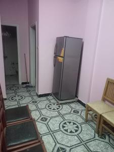a room with a refrigerator in the corner of a room at Villa El kheer in `Ezbet el-Dabdûba