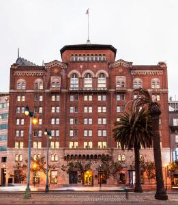 a large brick building with a palm tree in front of it at Harbor Court Hotel in San Francisco