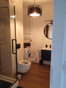 a bathroom with a toilet and a sink at City Lux Apartament Free Parking in Leszno