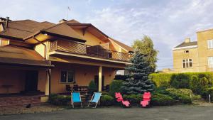 a group of chairs in front of a house at BedRooms 3 Maja 15A in Łódź
