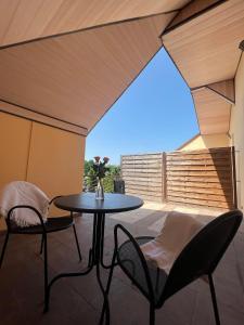 a patio with a table and chairs on a patio at BedRooms 3 Maja 15A in Łódź