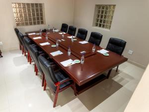a large conference room with a large wooden table and chairs at Global Village Guest House in Nelspruit +19 photos