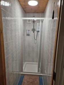 a bathroom with a shower with a shower curtain at Woodvale Bungalow in Little Haven