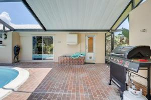 a backyard with a grill and a swimming pool at Family Home W Pool, Dining Room, And Golf View in North River Shores