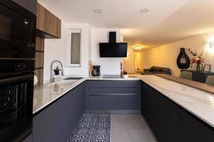 a kitchen with a sink and a counter top at Luxury Family Apartment close to Mgarr ix-Xini with Parking in Xewkija