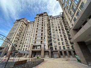 a large apartment building in front of a building at Diamond city in Bishkek