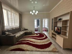 a living room with a couch and a rug at Diamond city in Bishkek
