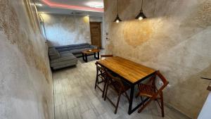 a living room with a table and a couch at Vila Argola - Spa Luxury Apartments in Belgrade