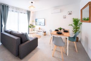 a living room with a couch and a table at Le Cool'Nest - Proche Disney et Val d'Europe 10mn in Esbly
