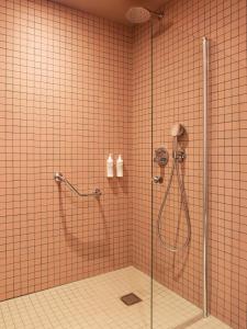 a bathroom with a shower with a glass door at New Hotel Opéra in Paris +37 photos