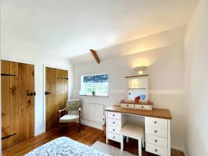 En eller flere senge i et værelse på Wren Cottage North Norfolk