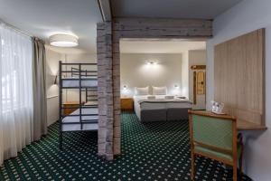 a hotel room with a bed and bunk beds at GENESIS by Eden in Predeal