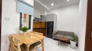a kitchen and dining room with a table and a couch at CH Home in Danang