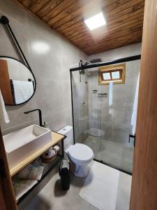 a bathroom with a toilet and a sink and a shower at Colina Branca in Rio Rufino +59 photos
