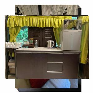 a kitchen with a sink and a microwave at Villa Sri Kampung in Kuah