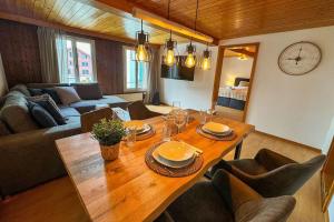 a living room with a wooden table with chairs at City Center View Apartment 2 in Interlaken