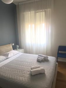 a bedroom with a bed with two towels on it at Sant'Orsola Malpighi Apartment in Bologna
